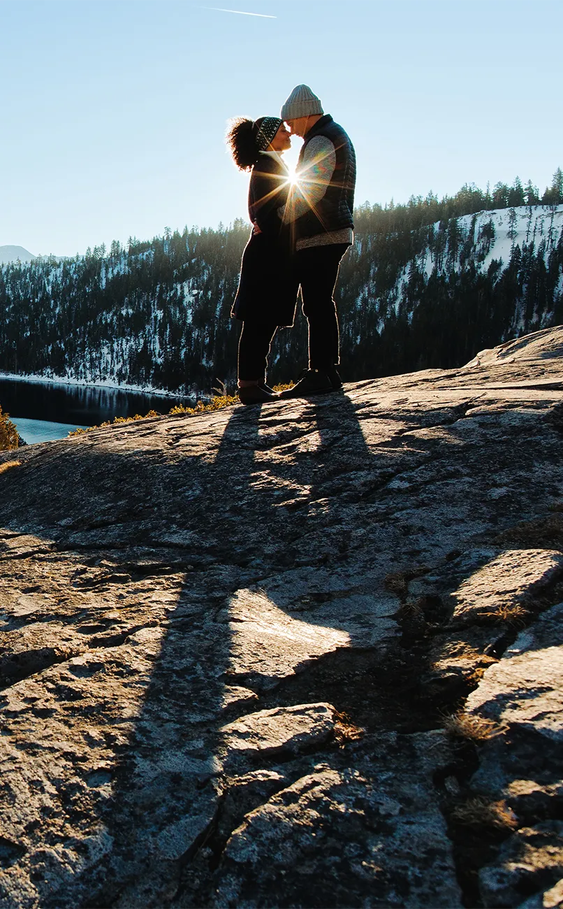 Couple standing in the mountains at winter time in Lake Tahoe area.