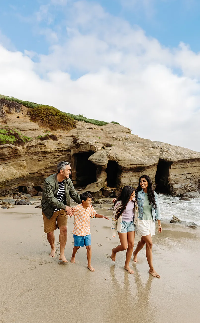 Family walking on the beach in San Diego area