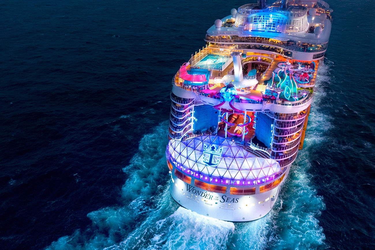 A cruise ship shines brightly as it sails on the open seas