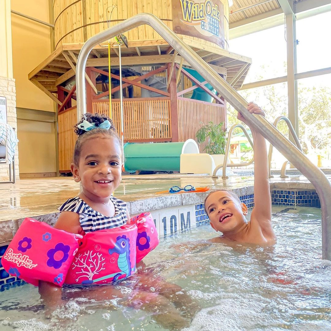 two young kids in indoor swimming pool