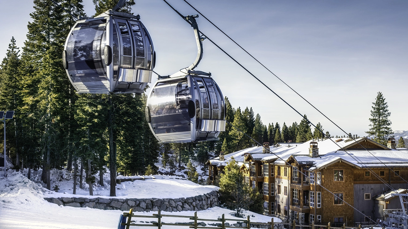 Two ski lift cars move in front of the Northstar Lodge