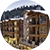 A snow-capped NorthStar Lodge in front of a forest