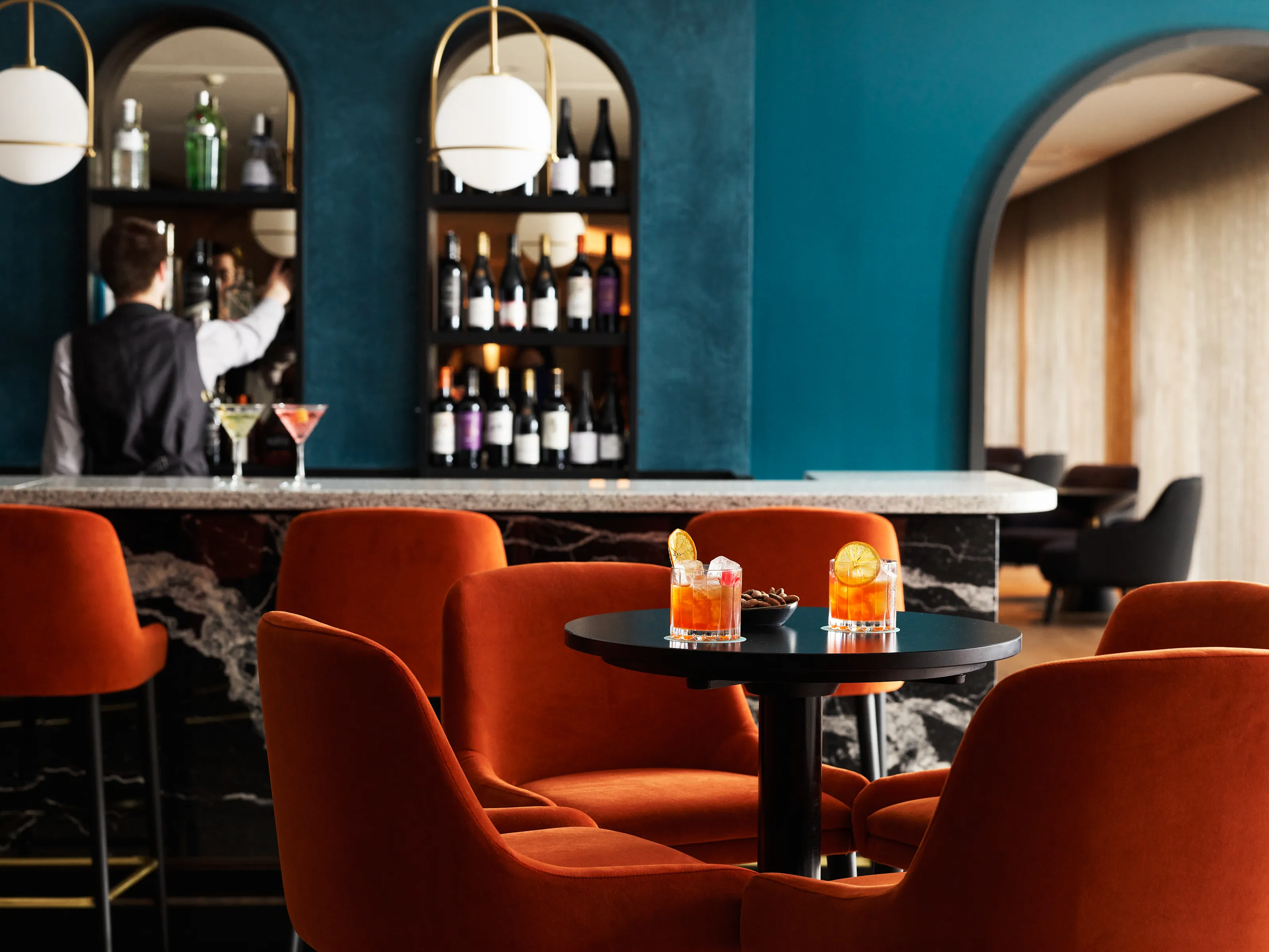 Bar shelves with bottles and mirrored backdrop.