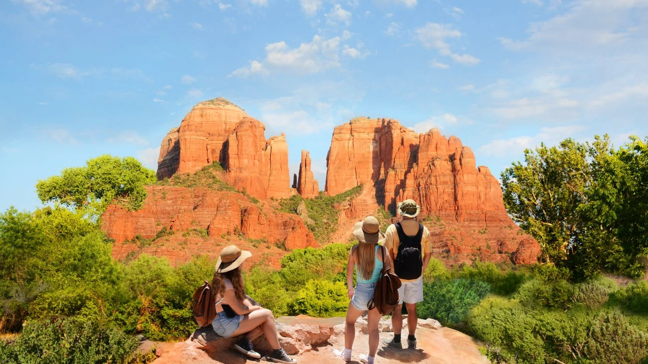 Family on hiking trip enjoying view of Cathedral Rock, Sedona, Arizona. 