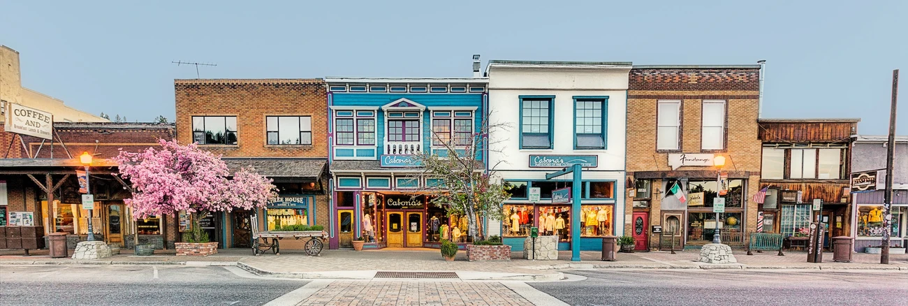 Colorful storefronts and parked cars along a street in downtown Truckee; the building labeled “Pastime” is visible at the far-right edge