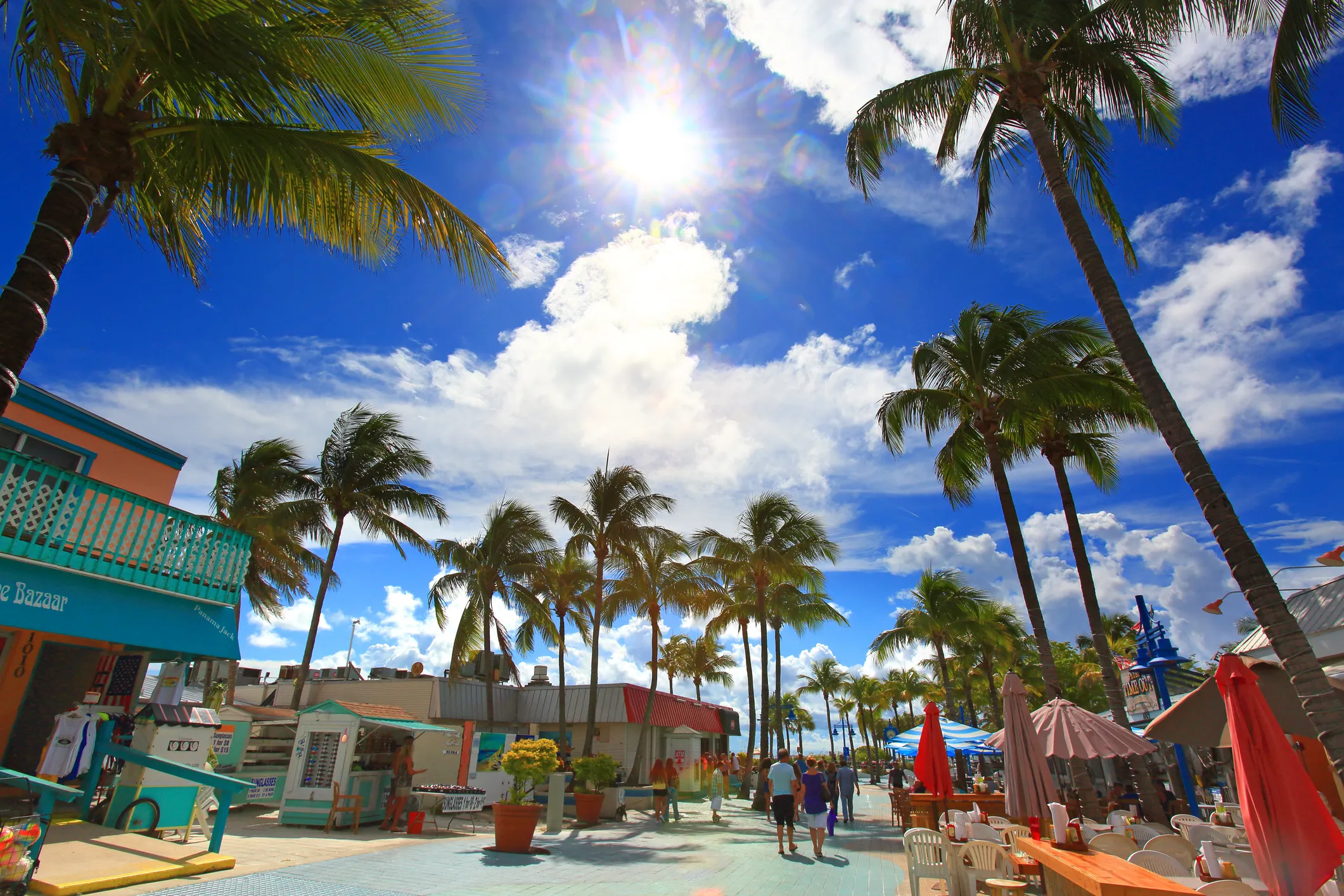 Boats docked along the waterfront in Fort Myers under a clear blue sky.