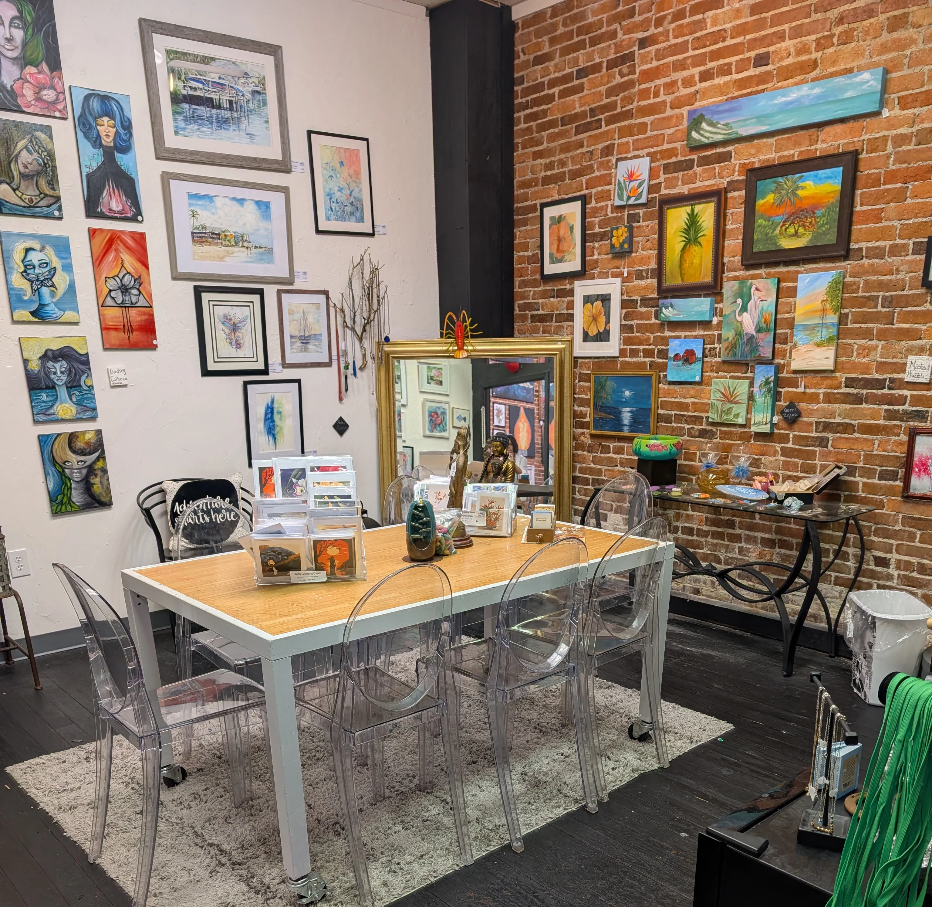 Framed artworks and sculptures featured in a local art gallery.