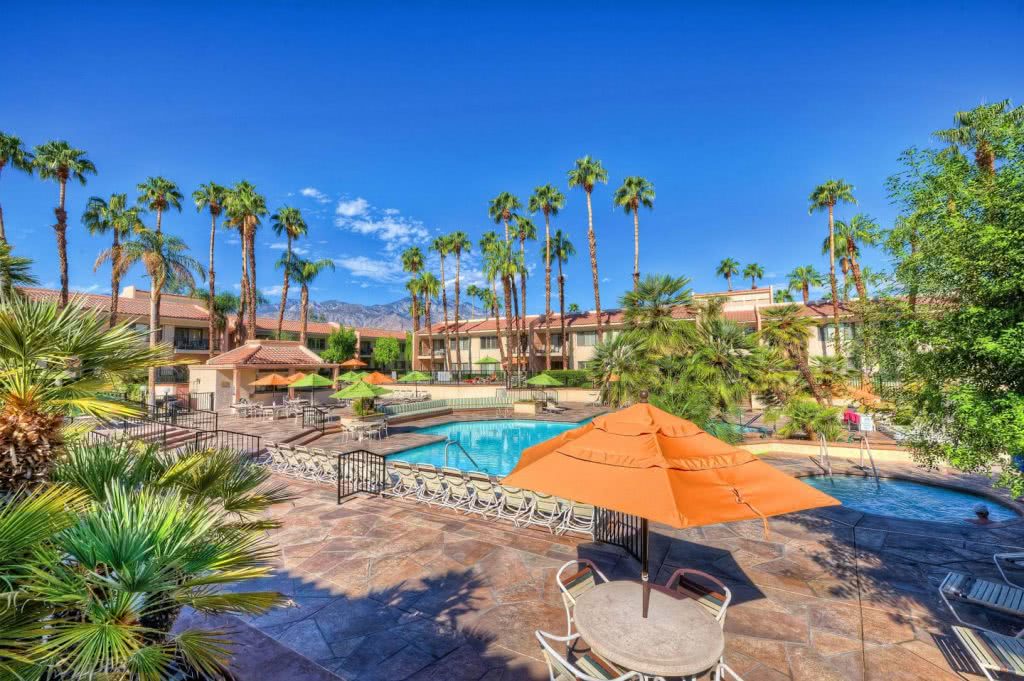 Mid-century modern styling in Palm Springs resort with pool and palm trees.