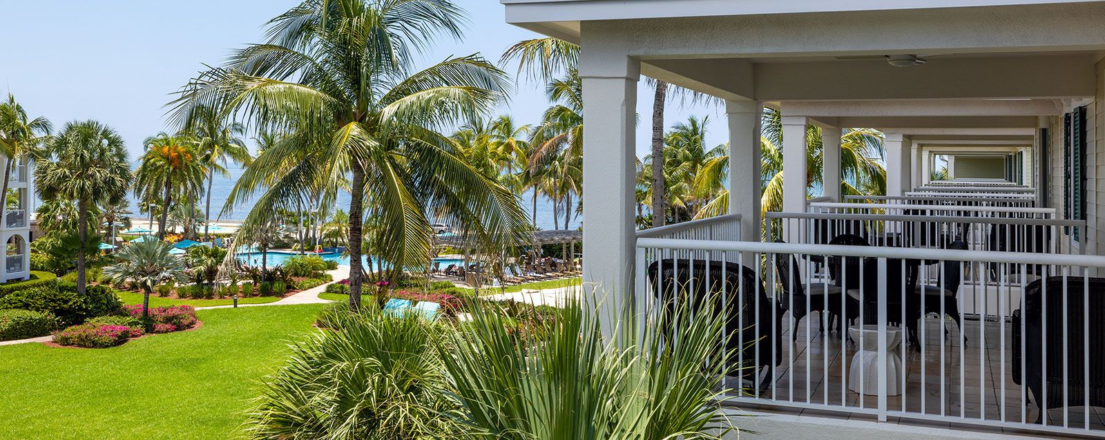 Poolside view with palm trees and ocean at a Key West resort