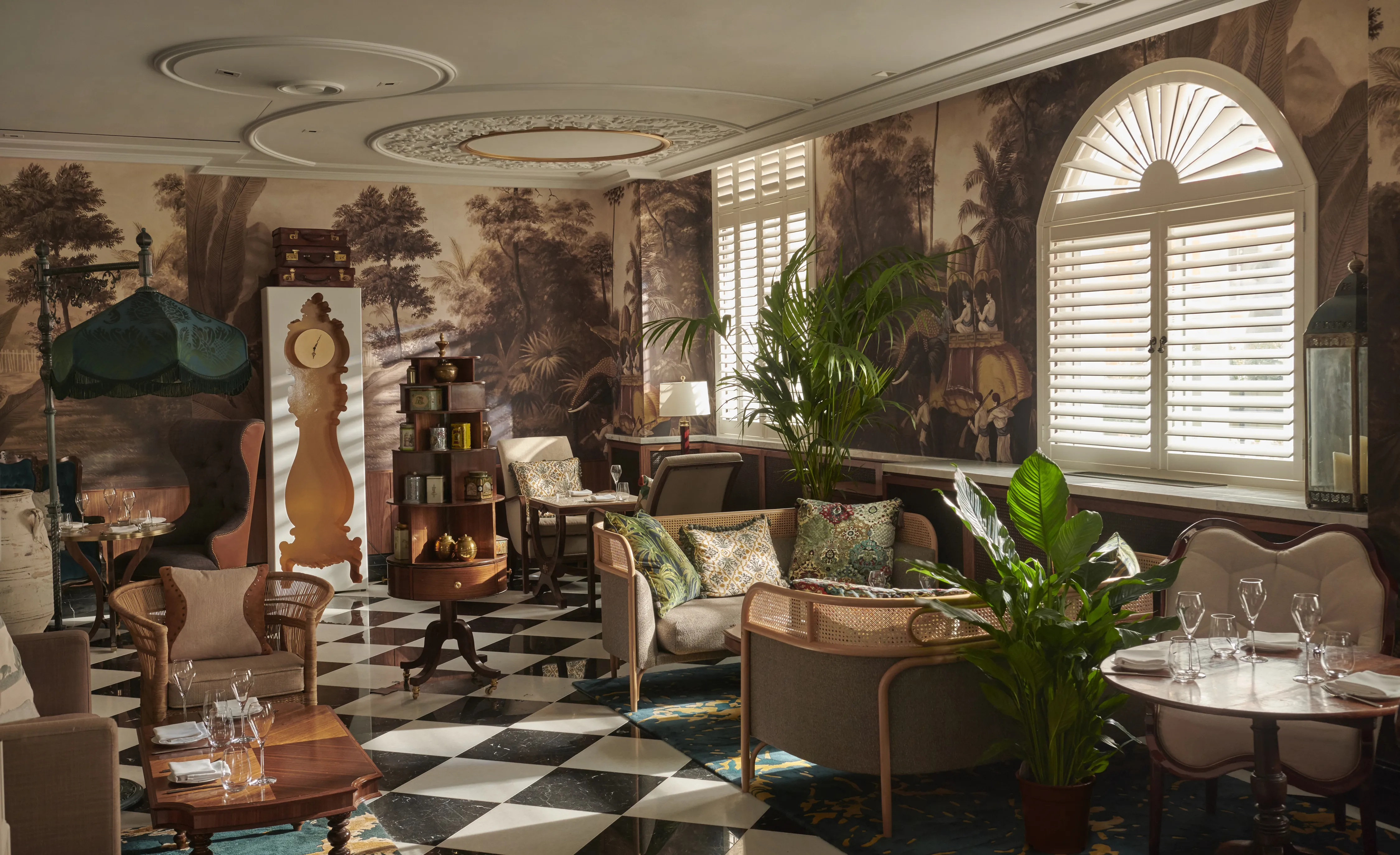 Elegant room with plush seating, fireplace, and ornate decor.