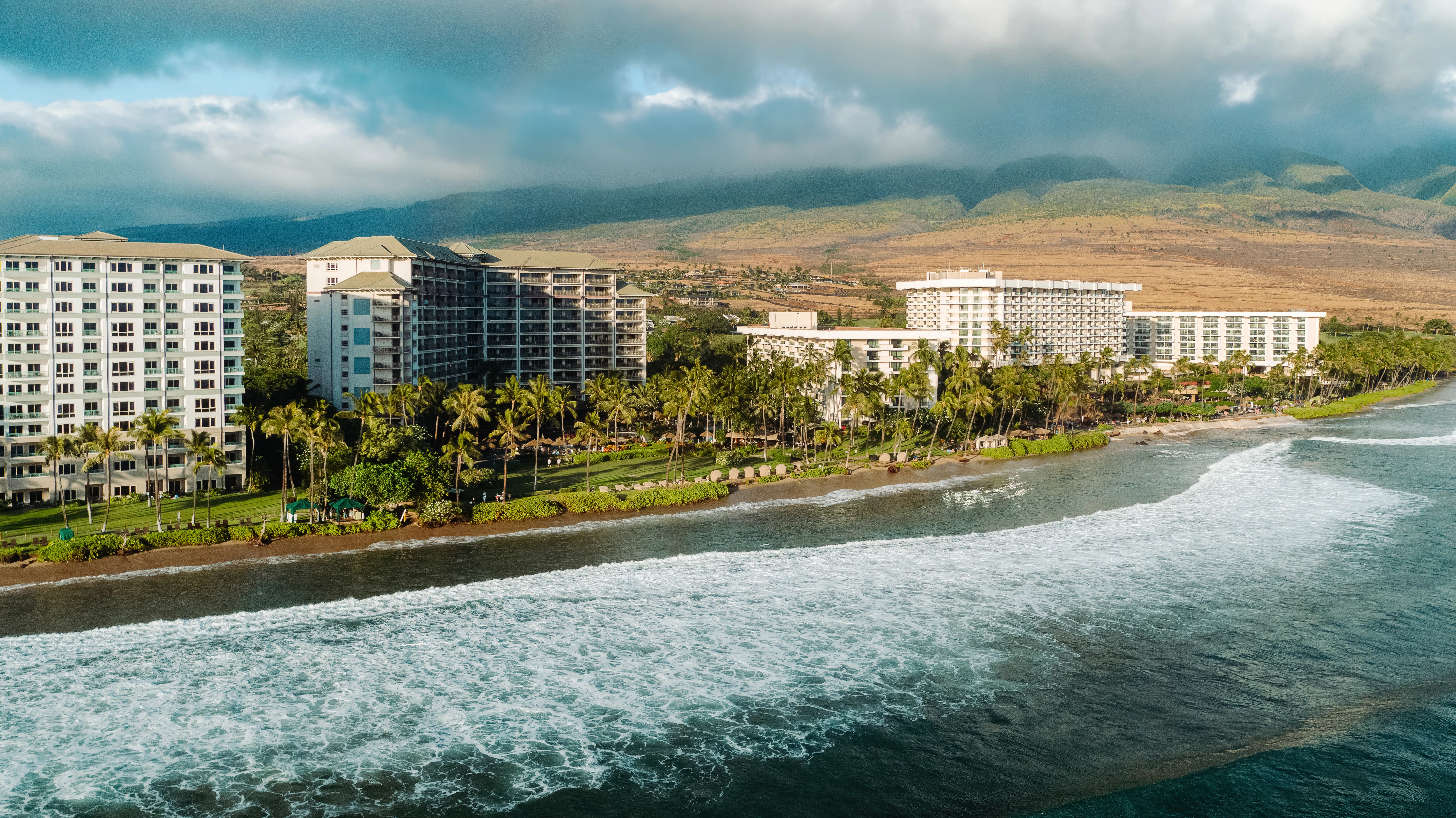 Aerial view of Hyatt Vacation Club at Kā‘anapali Beach featuring the pool area, tropical landscaping, and ocean backdrop.