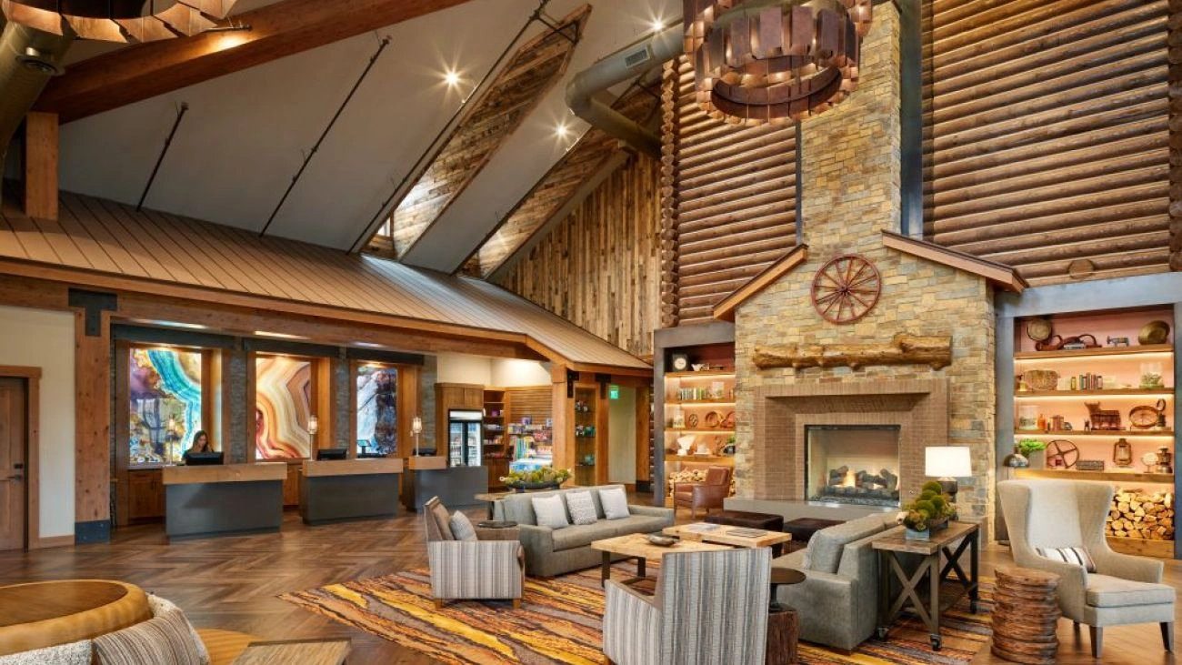 A tall stone fireplace and cozy seating areas at Hyatt Vacation Club at The Ranahan. 