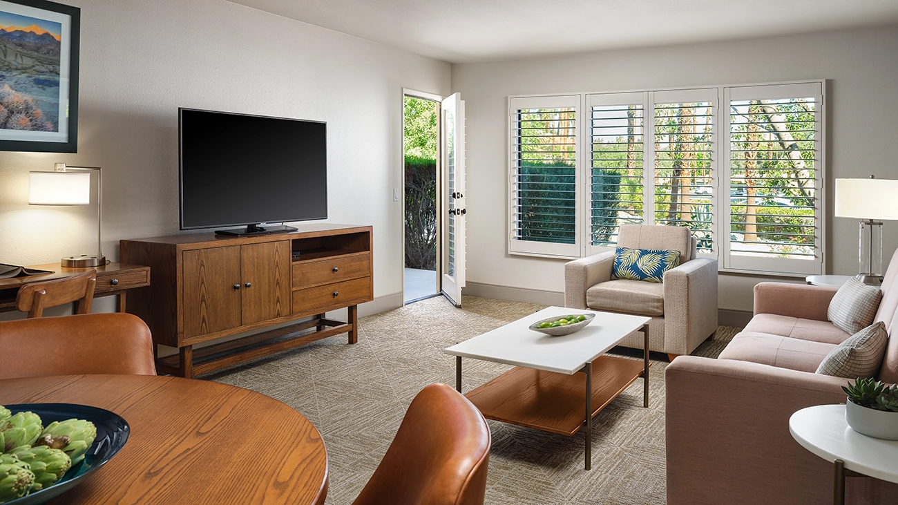 A flat screen TV and seating adorn a resort living area