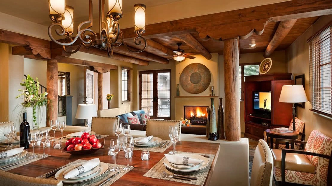 A roaring fire lights up the dining room as a fully dressed dining room table awaits food
