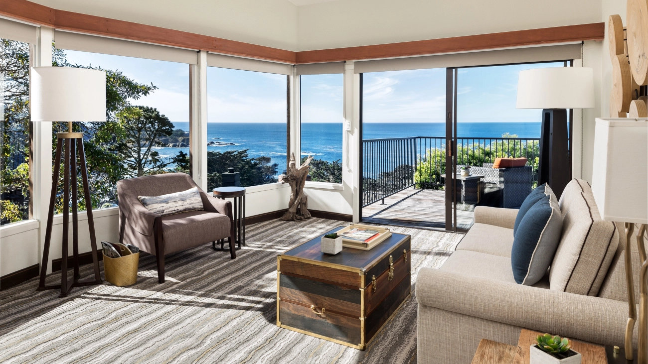 A sun-filled reading room sits next to a furnished outdoor patio