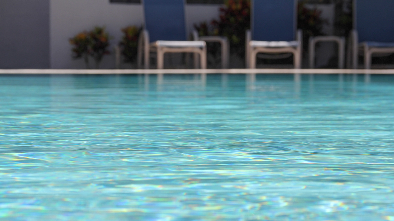 Closeup of the refreshing, shimmering waters of a resort pool