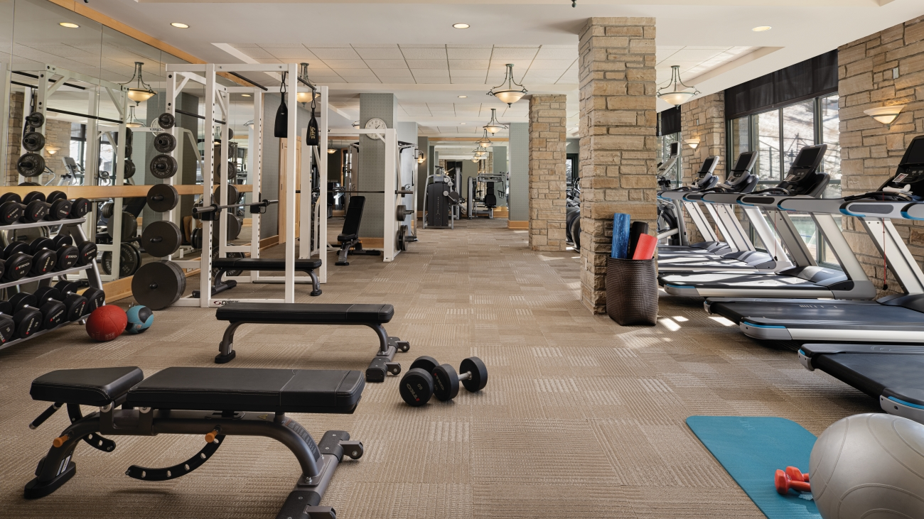 Well-appointed fitness center with free-weights, treadmills, and yoga mats