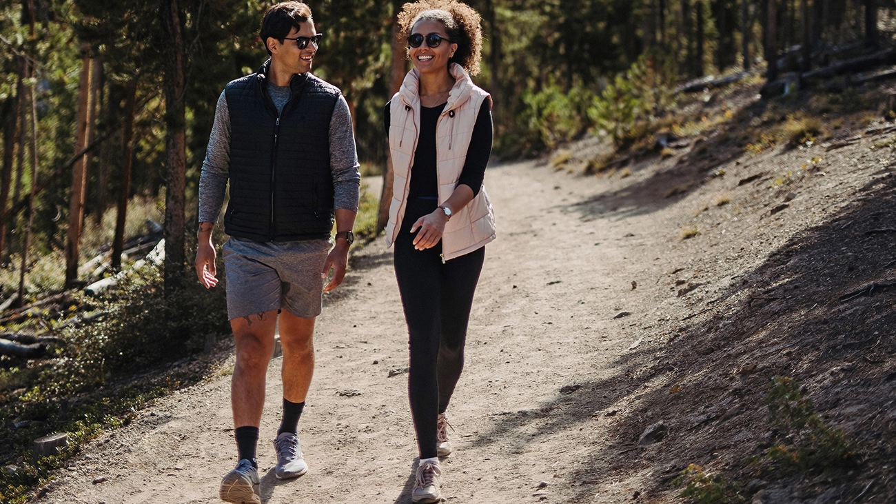 Happy couple hiking along a scenic mountain trail