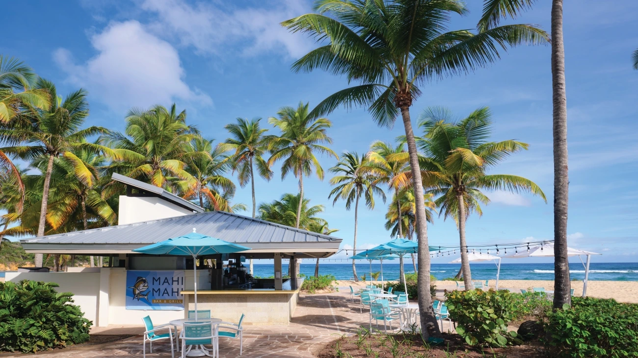 Restaurant on the beach with tables and umbrellas near the ocean