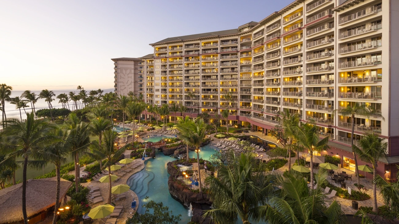 Beachside Hawaiian resort with shimmering pool and palm trees swaying the breeze