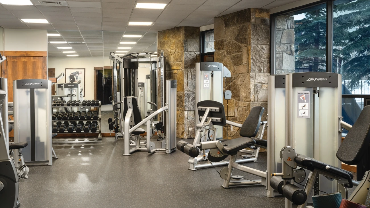 Fitness machines and weights sit in a fitness center