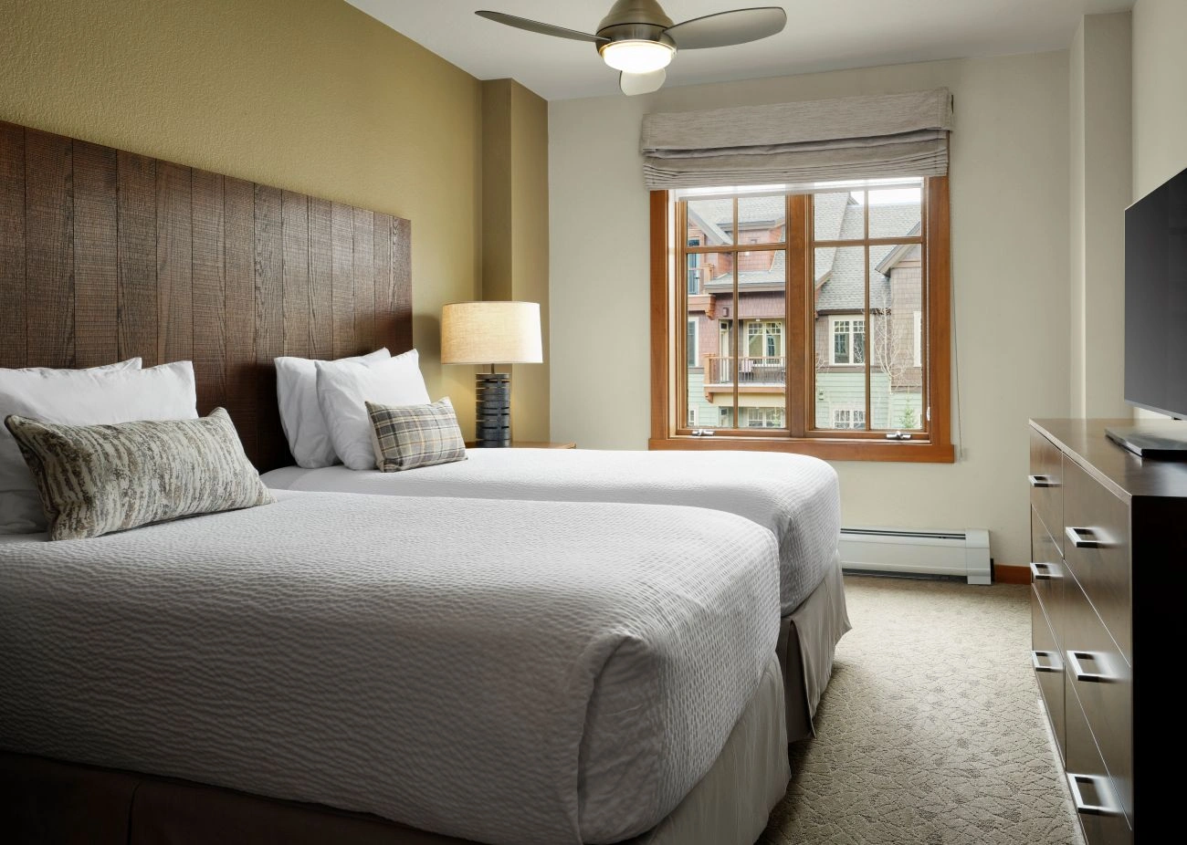 View of villa bedroom with rustic wooden headboard