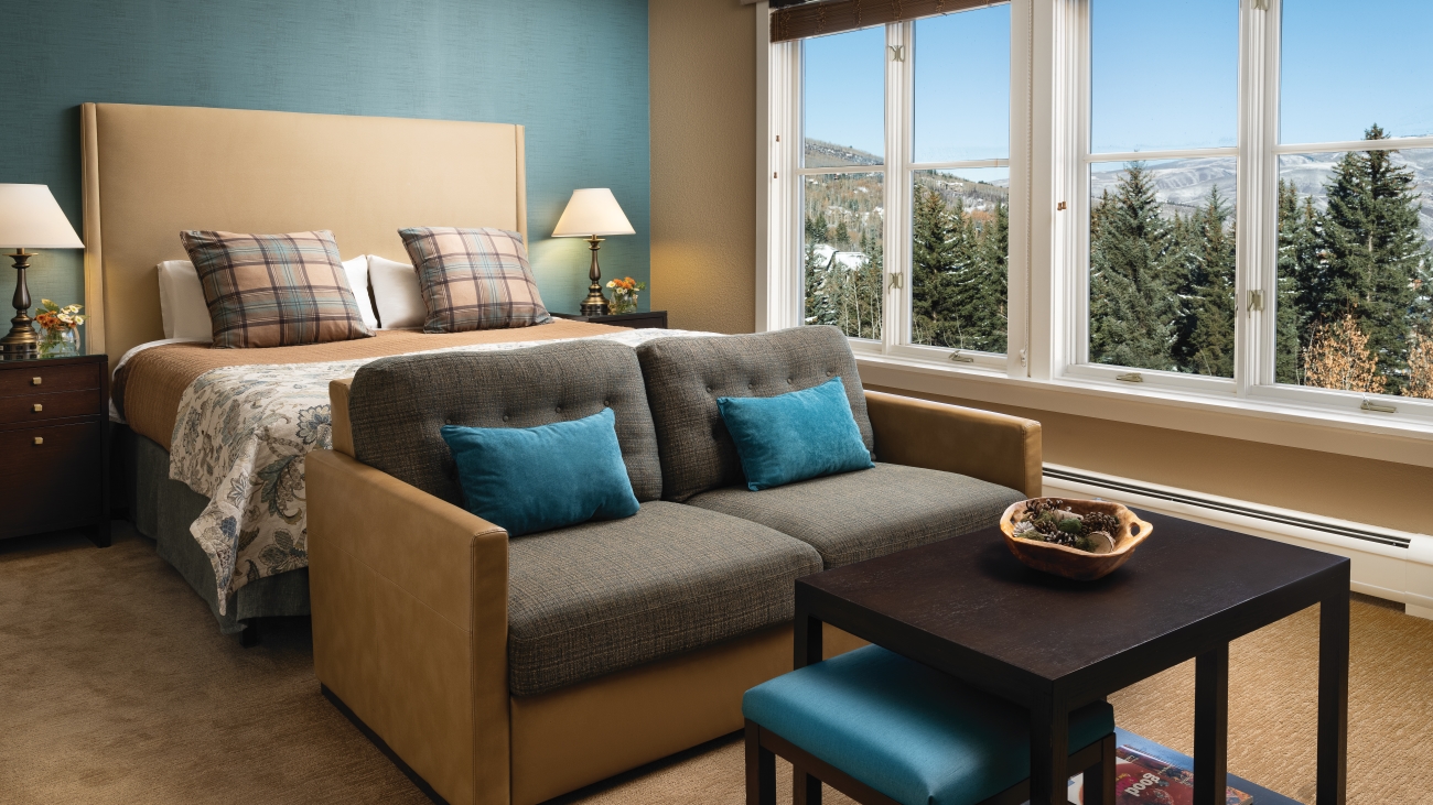 A couch and bed sit in one of the resorts bedrooms