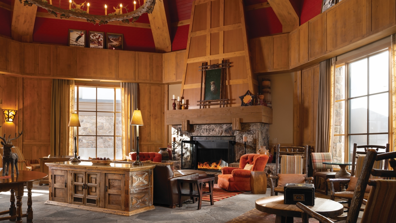 Large, richly appointed room with high ceilings, chandelier, and working fireplace