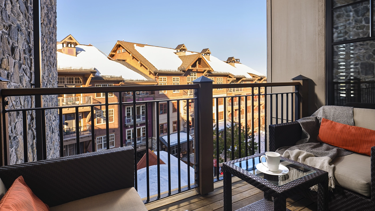An outdoor patio overlooks the rest of the snow-covered resort