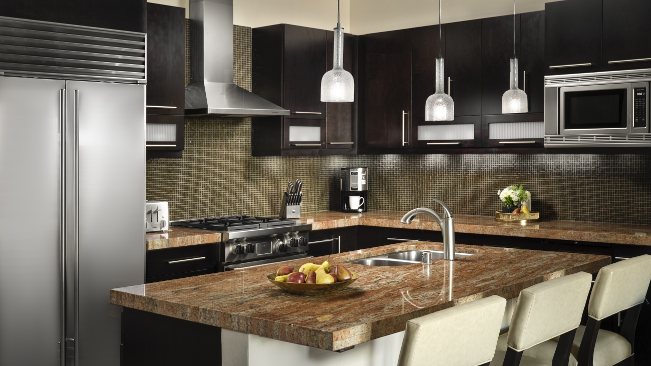 A modern and fully equipped kitchen with fridge, range, and microwave