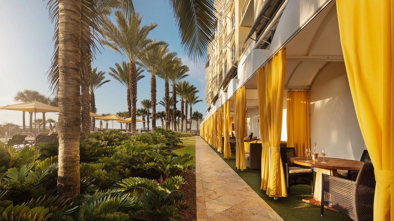 The sun shines gently on the outdoor patios at the Siesta Key Beach resort
