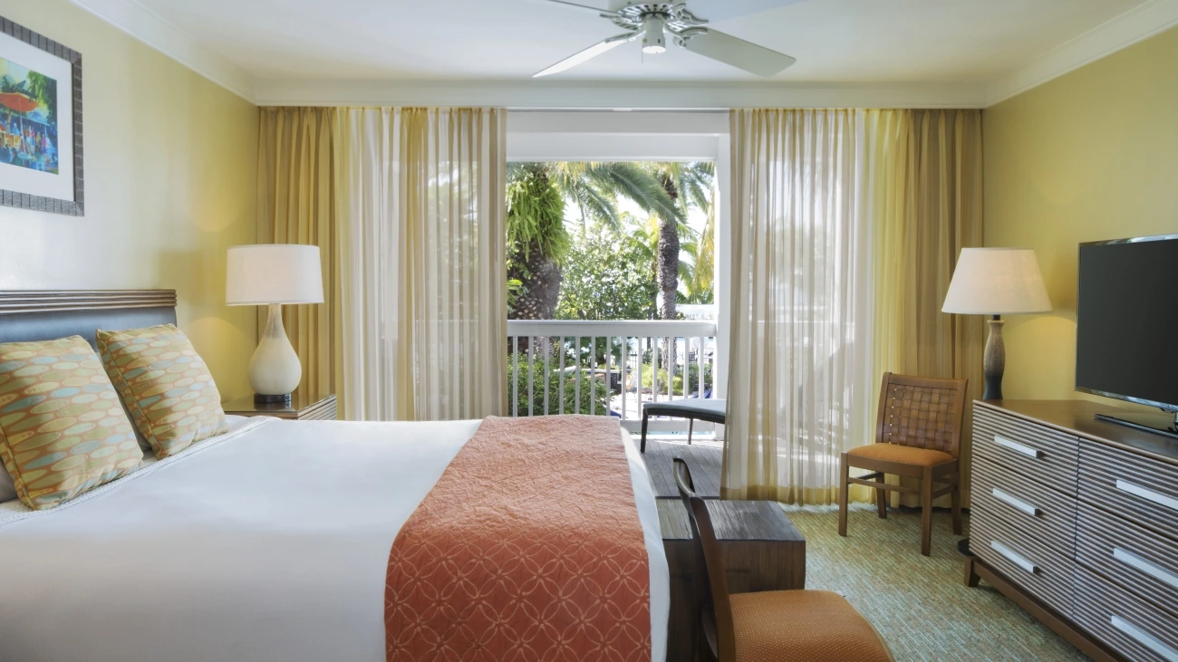 Resort bedroom with decorative pillows and HDTV
