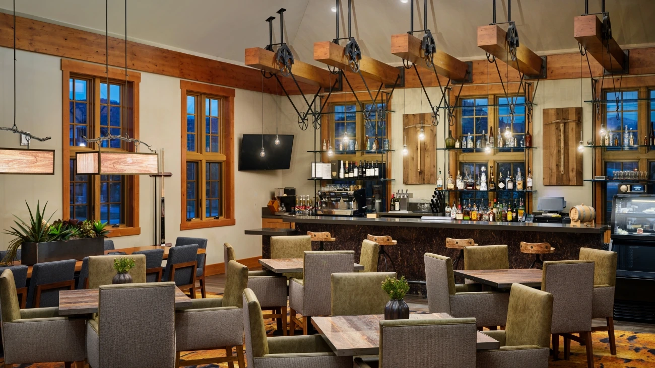 An espresso machine and bar provide drinks for a full indoor seating area