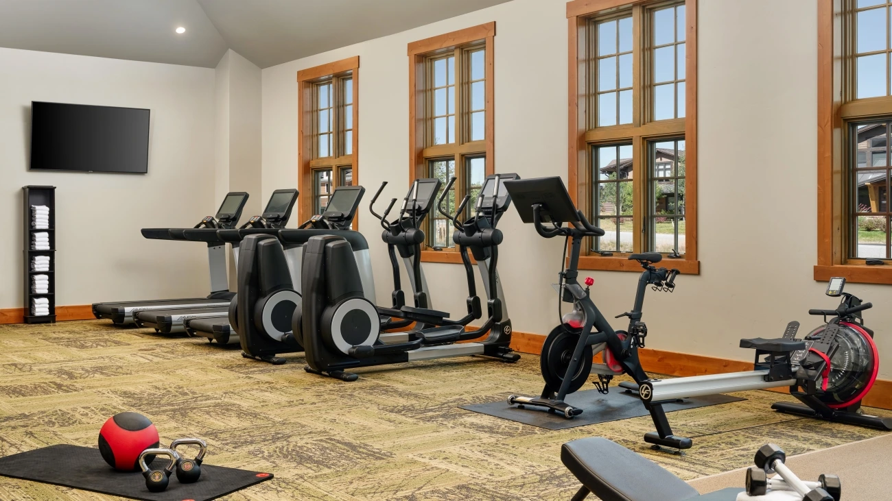 A group of treadmills face the windows in the resort's fitness center