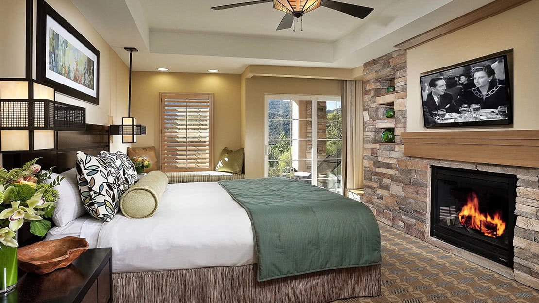 Interior view of villa bedroom with HDTV and working fireplace