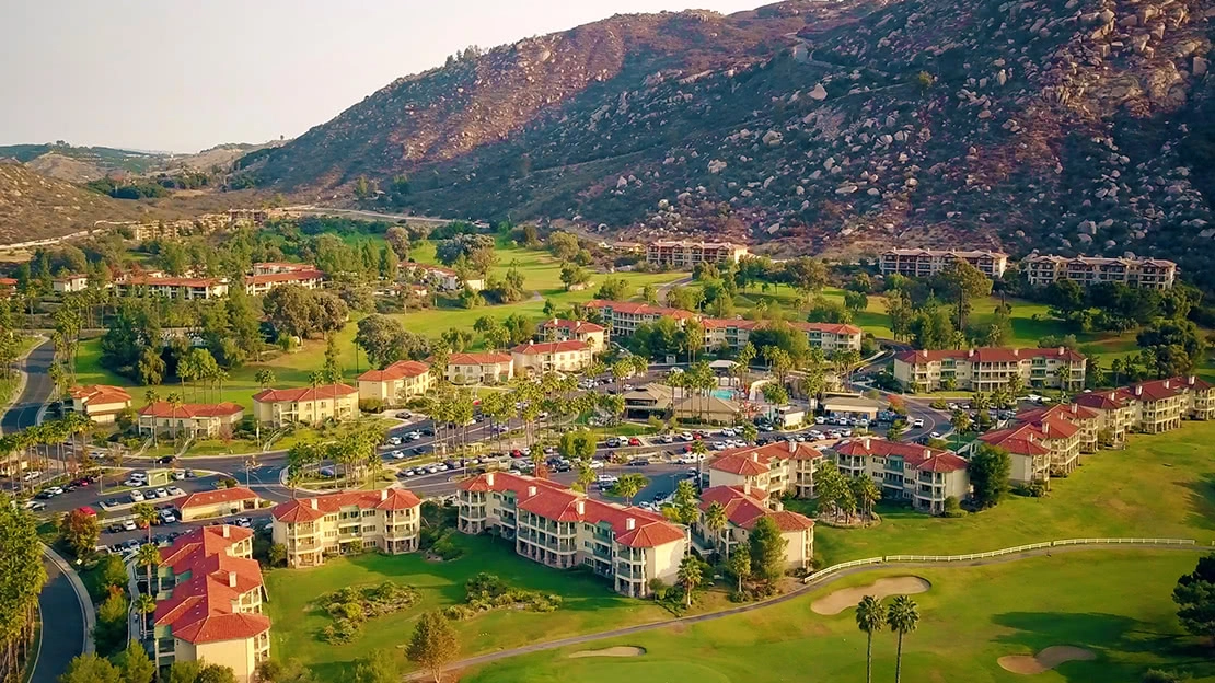 Aerial view of golf course, resort villas, and desert mountains