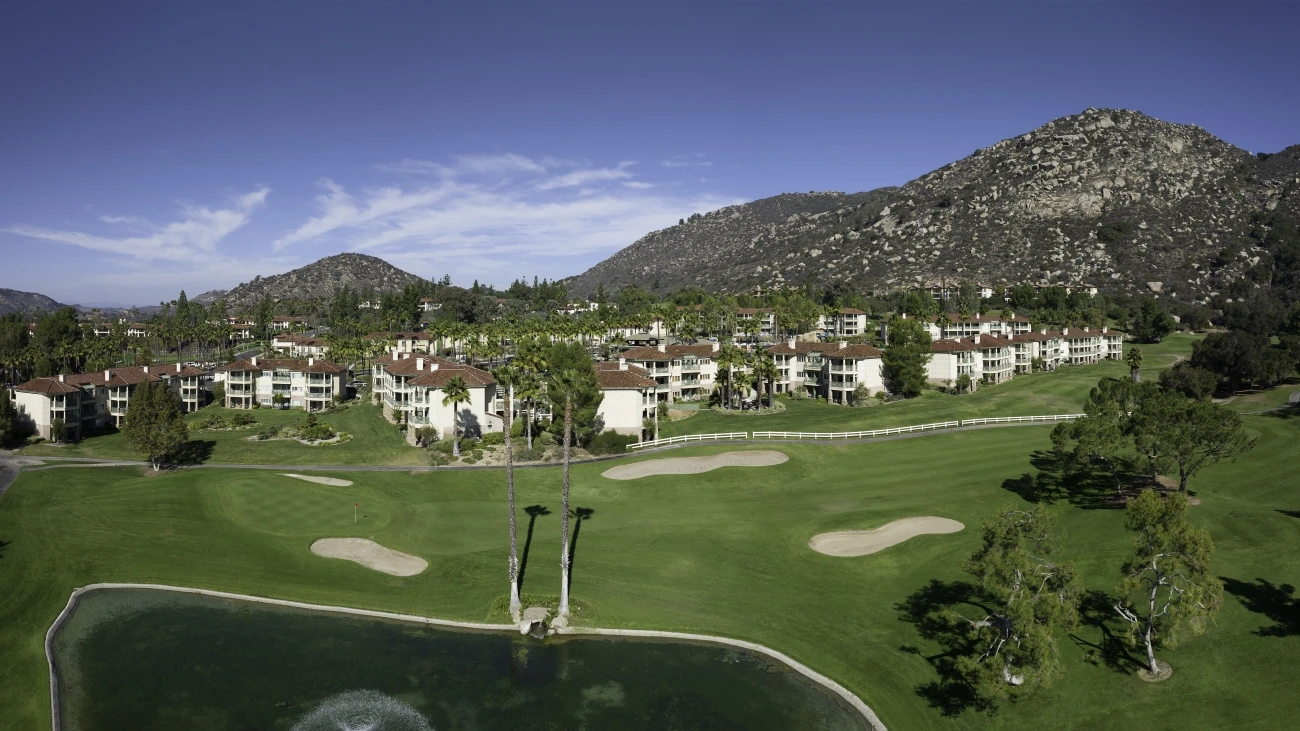Aerial view of golf course, resort villas, and desert mountains
