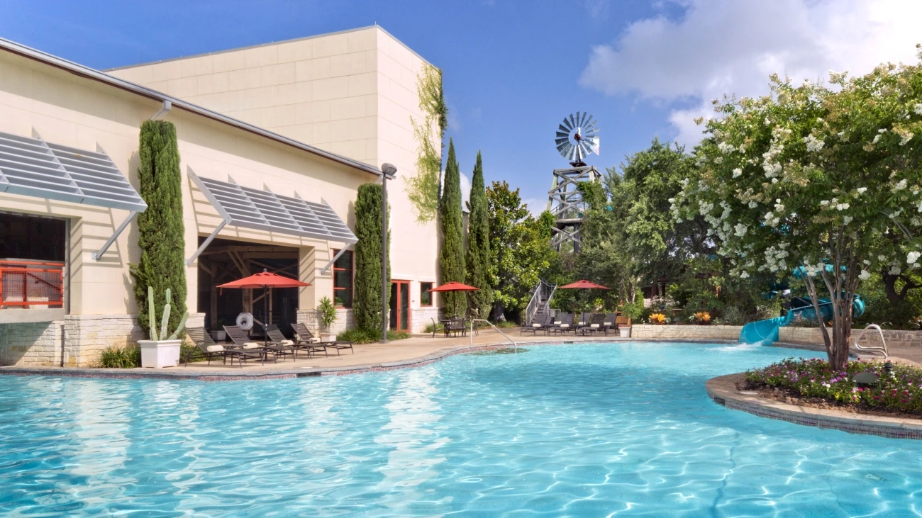 The clear blue waters of a pool sit just outside the resort entrance
