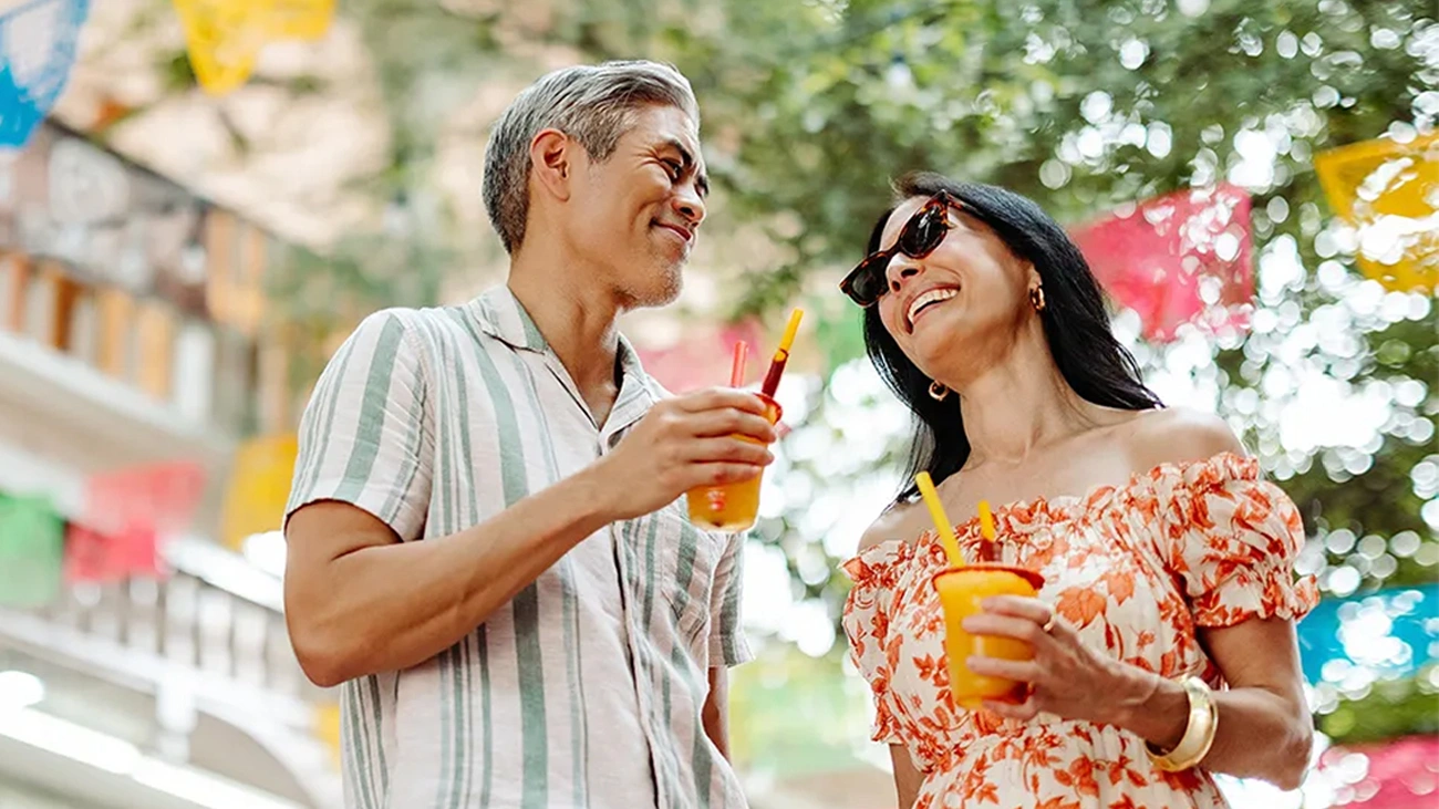 A couple laughing with drinks